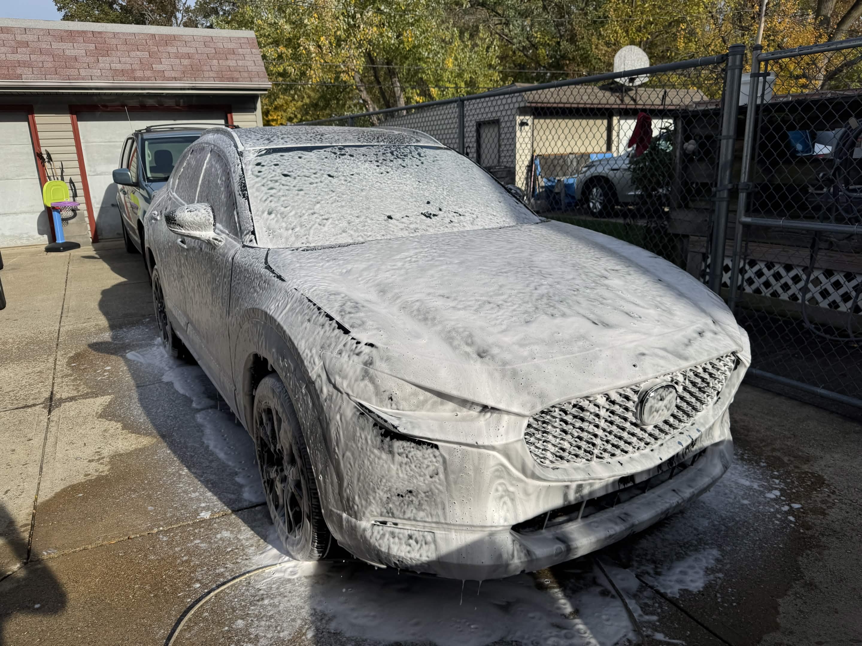 SUV covered in thick foam during a Cleveland exterior car detailing wash